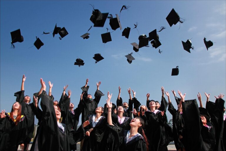 People throwing graduation caps.