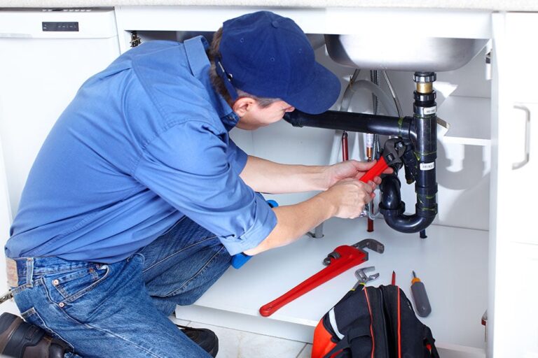 Plumber under a sink.