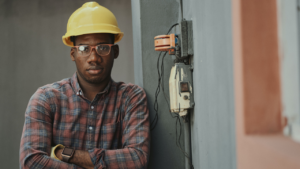 Man in glasses and a hardhat looking at the camera.