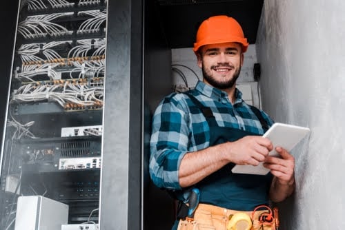 Construction worker smiling wearing hard hat.