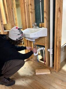 Male student working on a sink