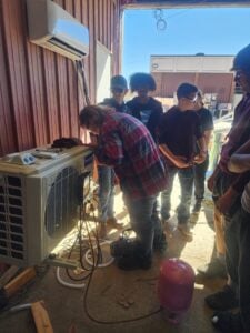 Students working on an air conditioner