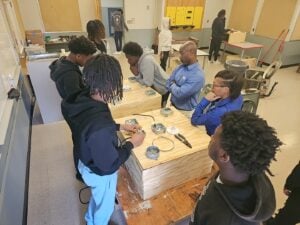 Students working with a lightbulb