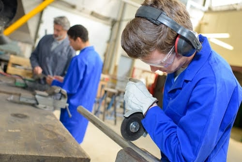 Trade school student welding.