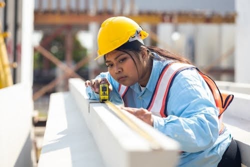 Young construction worker in yellow hard hat.
