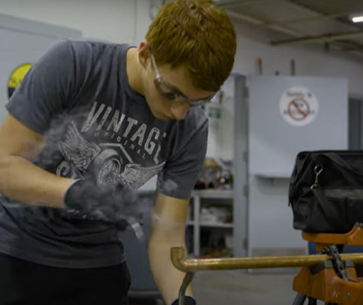 Trades student welding.