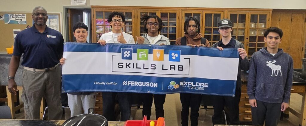 People standing behind a banner.