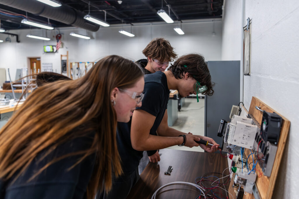 Kids working on an electrical panel.