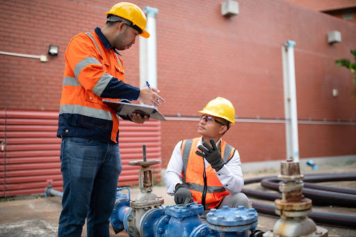 Plumbers in hard hats.